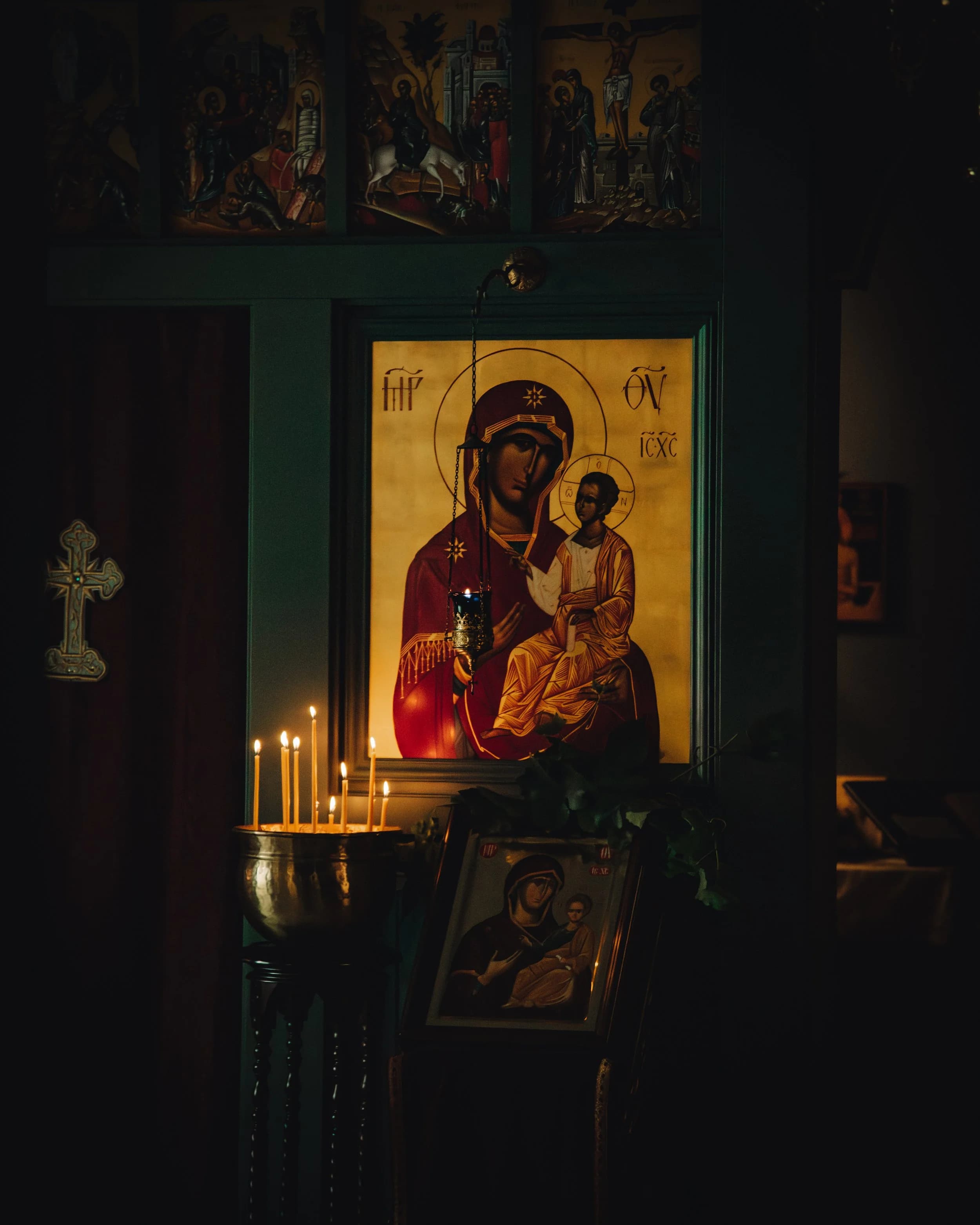 A Theotokos icon in a warm Orthodox church setting.